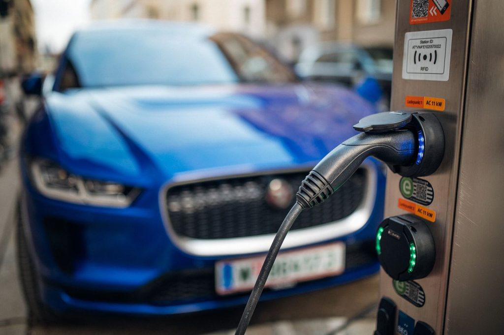 An electric car plugged into a charging station